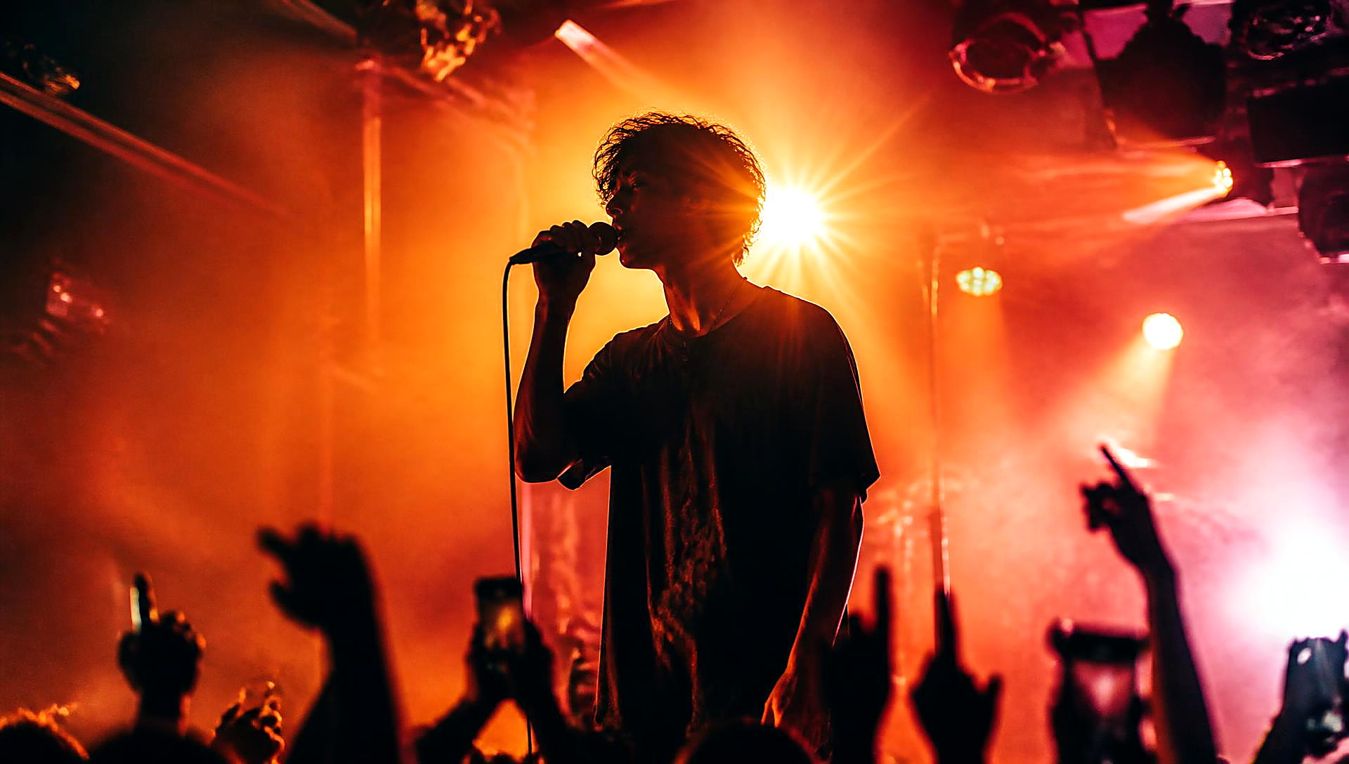 Singer performing under warm stage lights
